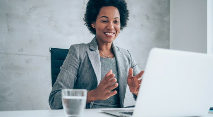 A woman deciding it is worth paying a financial advisor. 